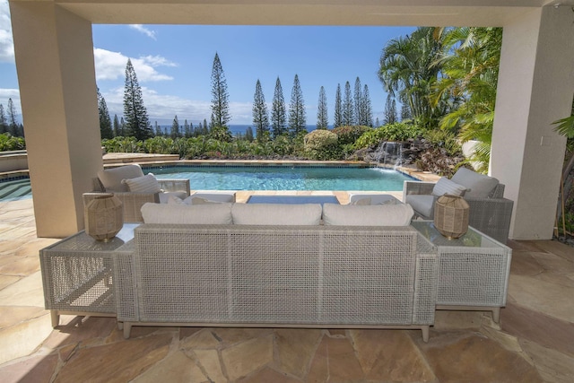 pool with an outdoor hangout area and a patio