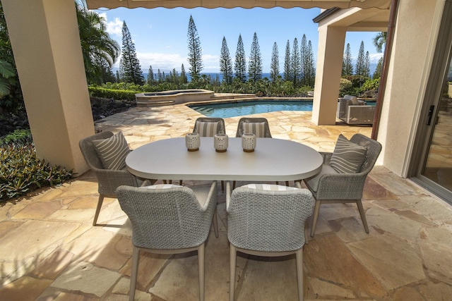 view of patio featuring an outdoor pool and an in ground hot tub