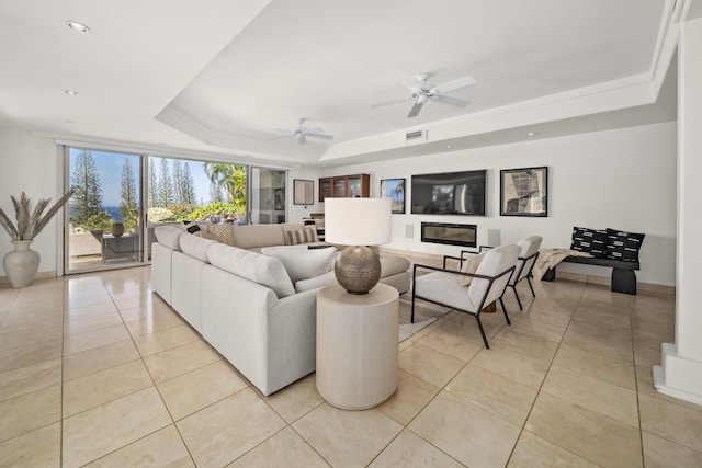 living room with light tile patterned floors, ceiling fan, a raised ceiling, and recessed lighting