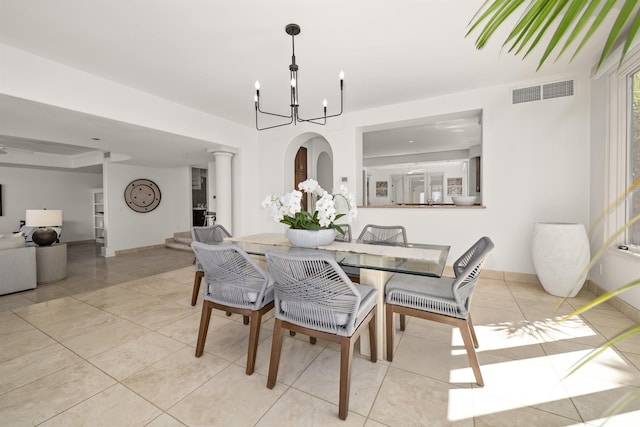 dining room with an inviting chandelier, baseboards, light tile patterned floors, and visible vents