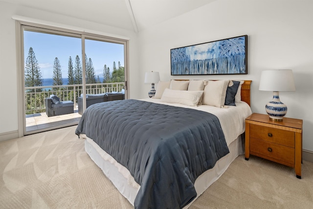 bedroom with access to outside, light colored carpet, and lofted ceiling