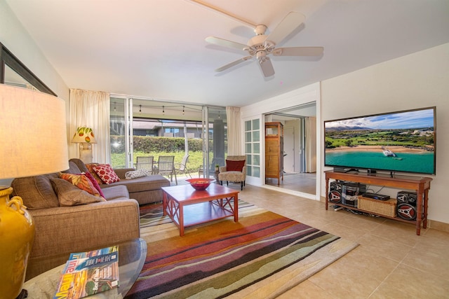 living room with a wall of windows, tile patterned floors, and ceiling fan