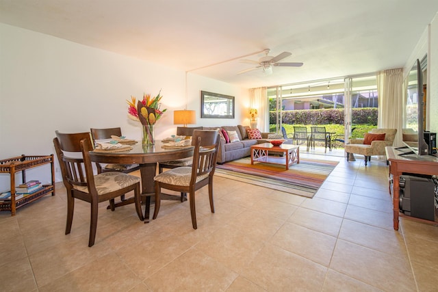 dining room with floor to ceiling windows, ceiling fan, and light tile patterned flooring