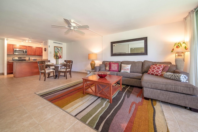 living room with light tile patterned floors and ceiling fan