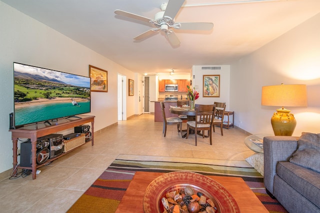 living room featuring light tile patterned floors and ceiling fan