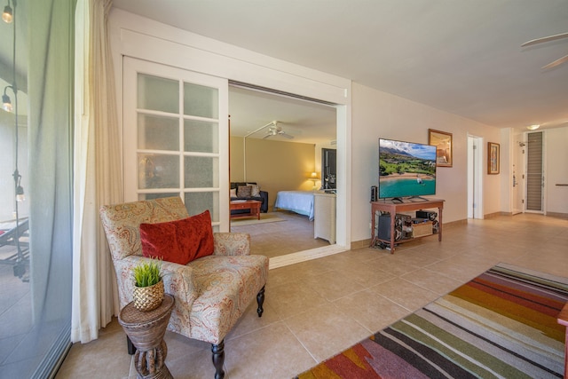 tiled living room with ceiling fan