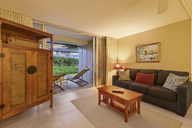 living room with expansive windows, ceiling fan, and light tile patterned flooring