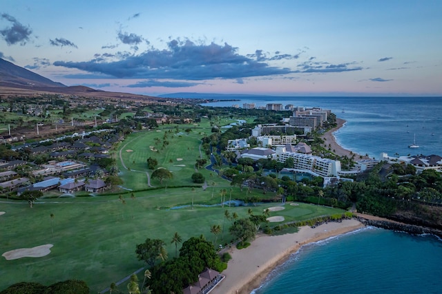 aerial view at dusk featuring a water view