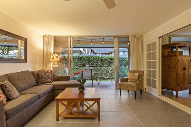 living room with ceiling fan, track lighting, and tile patterned flooring