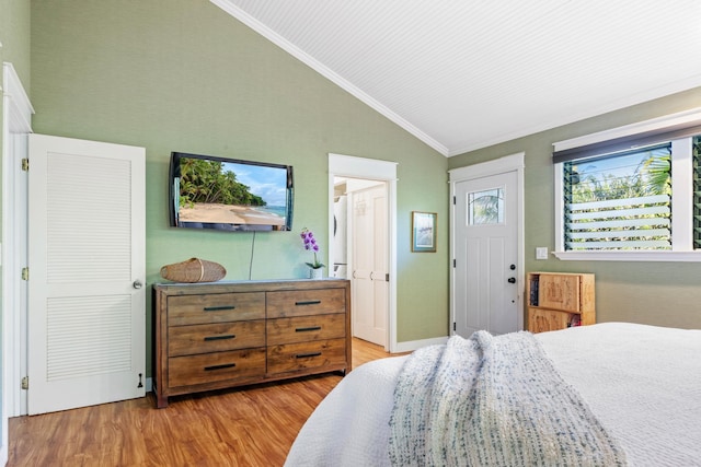 bedroom with ornamental molding, lofted ceiling, and light wood-style flooring