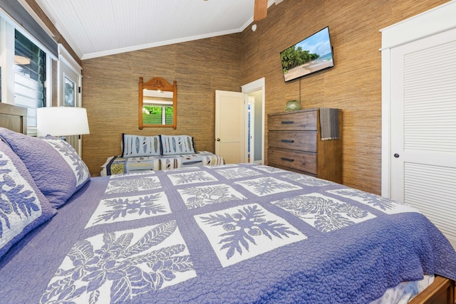 bedroom featuring ornamental molding, a closet, and vaulted ceiling