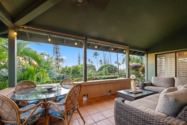 sunroom featuring lofted ceiling