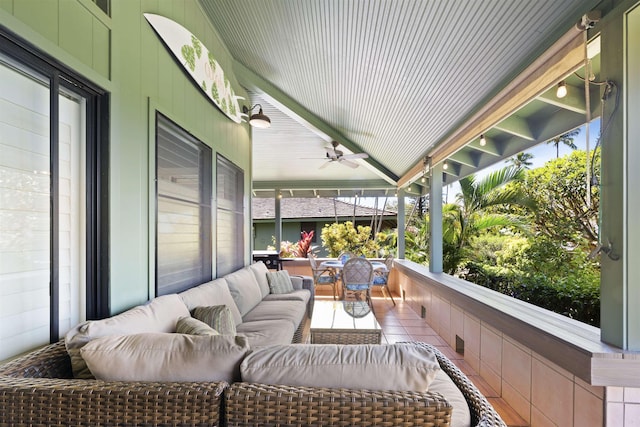 sunroom featuring ceiling fan