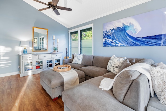 living room with baseboards, ceiling fan, ornamental molding, wood finished floors, and vaulted ceiling