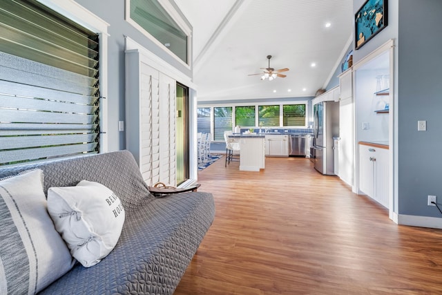 sunroom featuring vaulted ceiling and ceiling fan