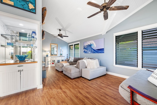 living area featuring crown molding, light wood finished floors, ceiling fan, high vaulted ceiling, and baseboards