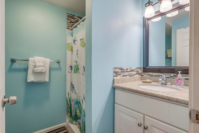 bathroom featuring decorative backsplash, vanity, and a shower with shower curtain