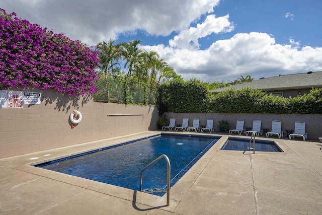 view of pool featuring fence, a fenced in pool, and a patio area