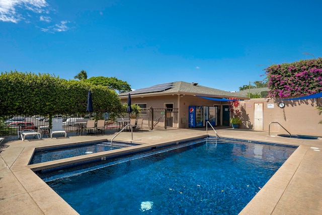 view of pool featuring a community hot tub and a patio