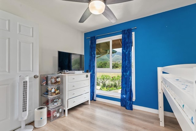 bedroom featuring baseboards, a ceiling fan, and wood finished floors