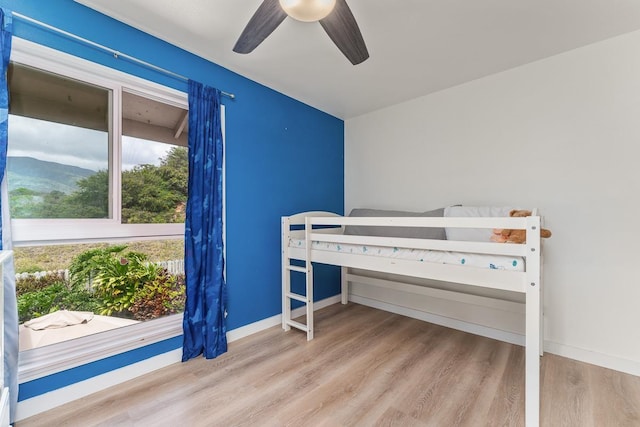 unfurnished bedroom featuring baseboards, ceiling fan, and wood finished floors