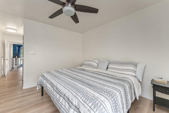 bedroom featuring baseboards, a ceiling fan, and wood finished floors