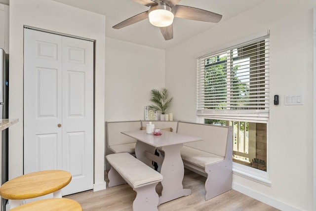 dining space with ceiling fan, a wealth of natural light, and light wood-type flooring