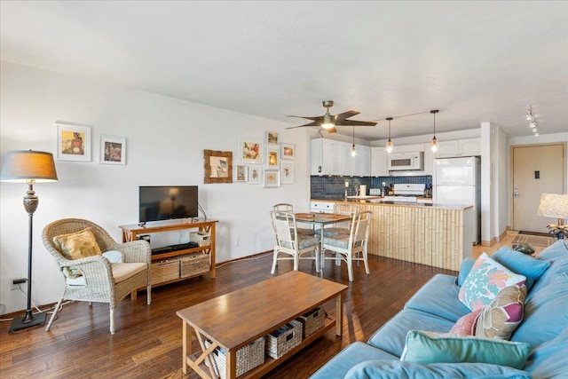 living room featuring dark hardwood / wood-style floors and ceiling fan