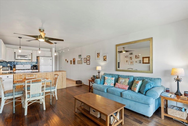 living room featuring dark hardwood / wood-style floors and ceiling fan