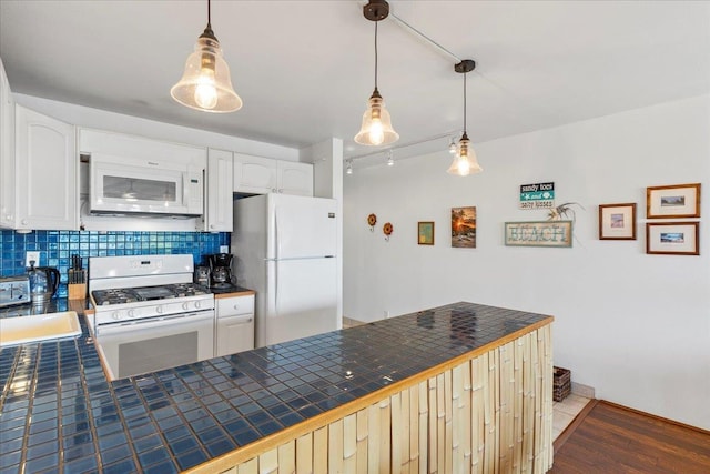 kitchen featuring white cabinetry, white appliances, tile countertops, and pendant lighting