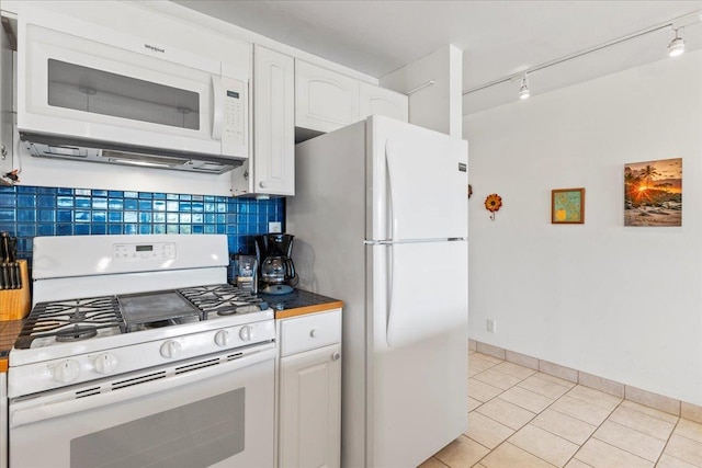 kitchen featuring white cabinetry, white appliances, decorative backsplash, and light tile patterned floors