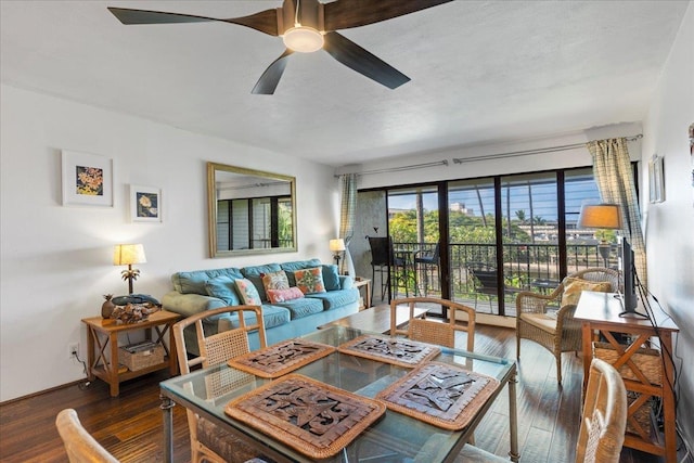 living room featuring ceiling fan, dark hardwood / wood-style flooring, and a textured ceiling