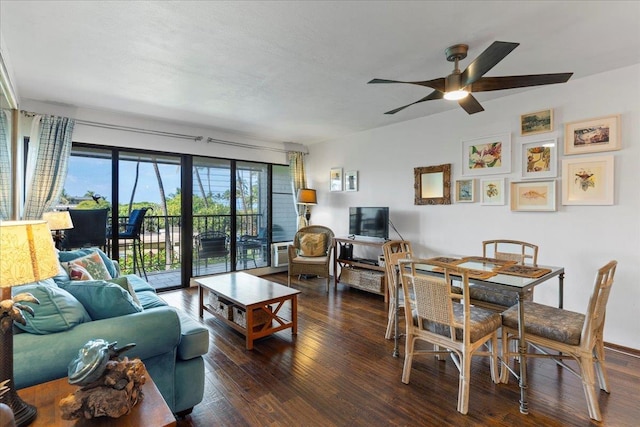 living room with dark hardwood / wood-style floors and ceiling fan