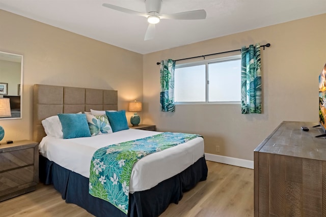 bedroom with light hardwood / wood-style floors and ceiling fan