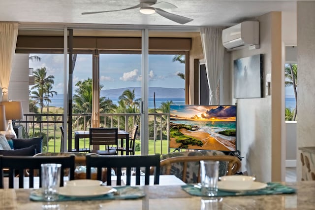 dining area featuring a wall mounted AC and ceiling fan