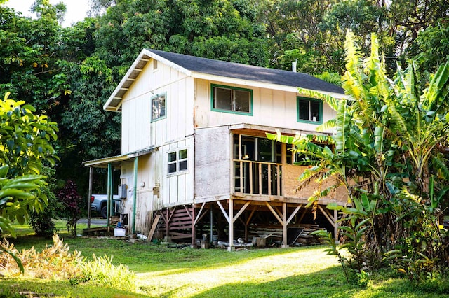 rear view of property with a yard