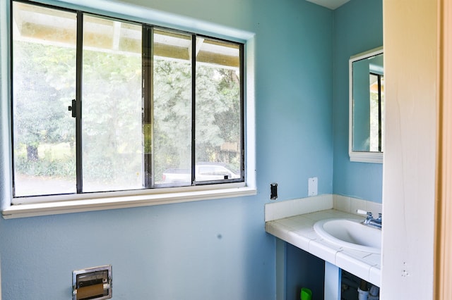 bathroom featuring sink and a wealth of natural light