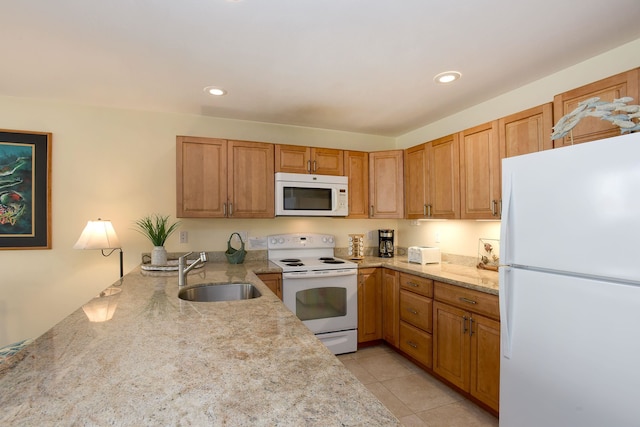 kitchen featuring sink, kitchen peninsula, light stone countertops, light tile patterned floors, and white appliances