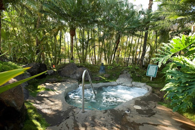 view of swimming pool featuring an in ground hot tub