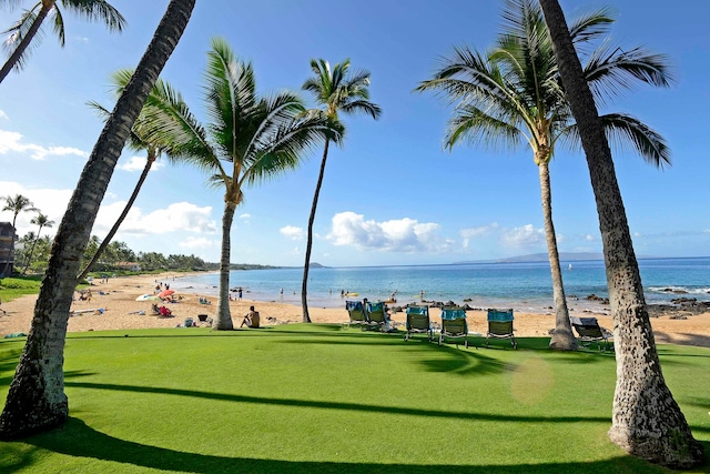 view of home's community with a water view and a beach view