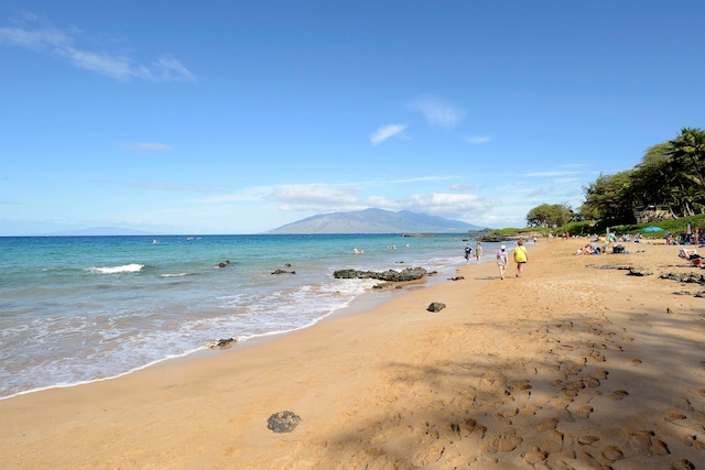 view of water feature with a mountain view and a beach view