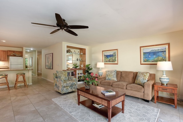 living room featuring ceiling fan and light tile patterned floors