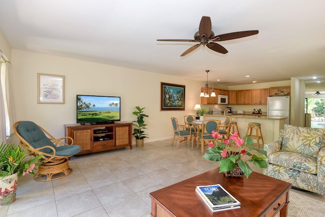 living room featuring ceiling fan with notable chandelier and light tile patterned floors