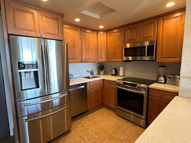 kitchen with light tile flooring, appliances with stainless steel finishes, and sink