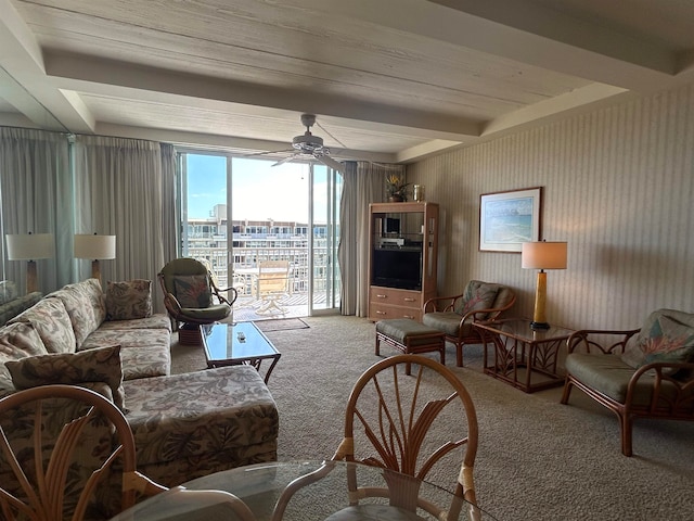 living room with carpet, ceiling fan, and beamed ceiling