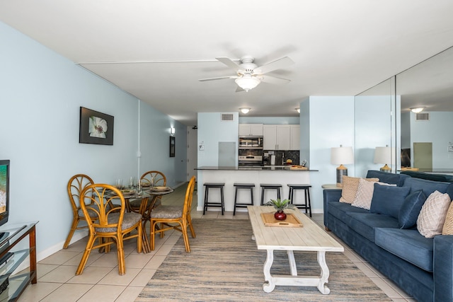 living room with light tile floors and ceiling fan