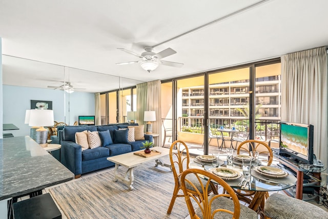 living room with ceiling fan and expansive windows