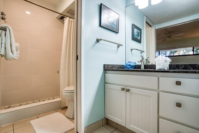 bathroom featuring vanity, tile flooring, ceiling fan, and toilet