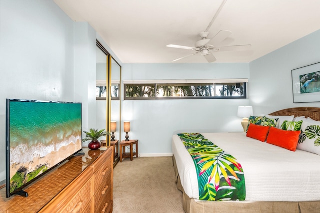 carpeted bedroom featuring a closet and ceiling fan