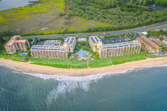 bird's eye view with a water view and a beach view